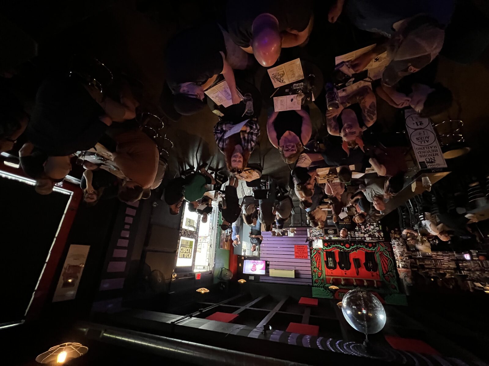 A packed game night in a dim bar